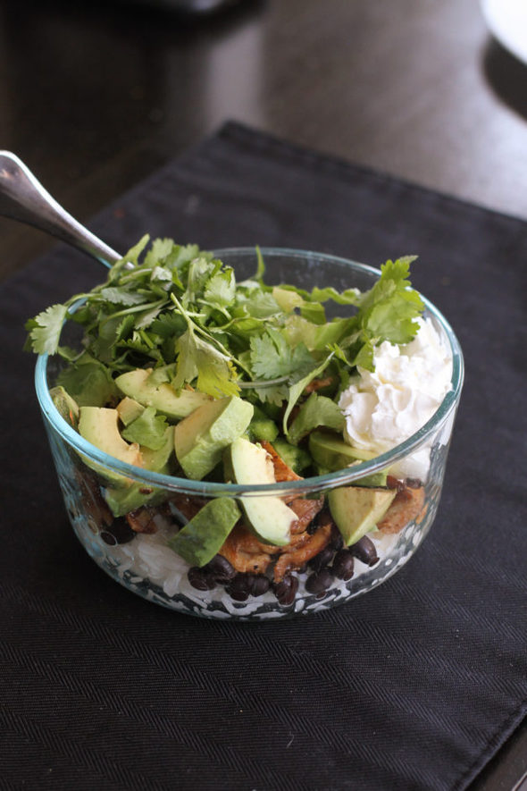 Burrito bowl topped with cilantro.